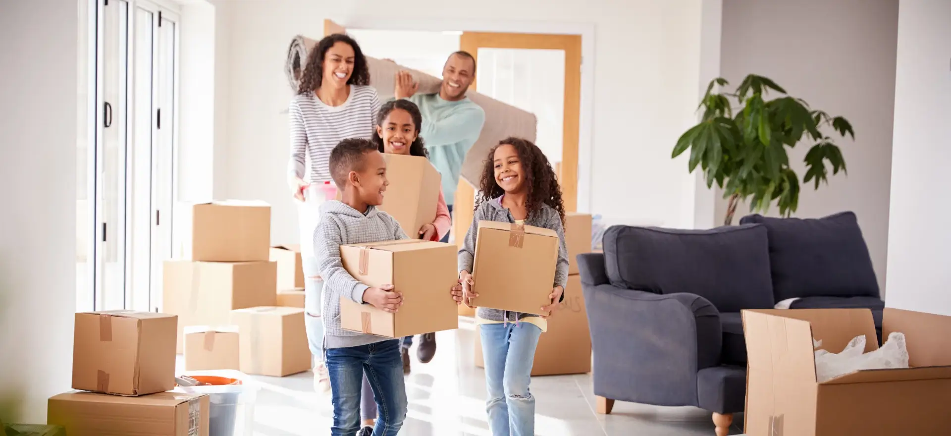 Happy family moving in to their new home thanks to Big Fish Mortgage Team